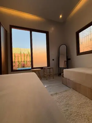 a bedroom with two beds and two large windows at Marrakech Private Villa with Pool, Near Ourika and Atlas Mountain in Aghmat
