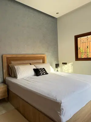 a bedroom with a large bed with white sheets and a window at Marrakech Private Villa with Pool, Near Ourika and Atlas Mountain in Aghmat