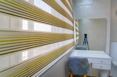 a desk and a chair in a room with a window at Elegance in Oulad Akkou