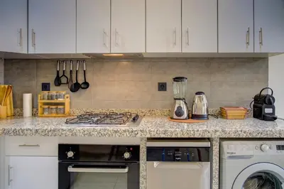 a kitchen with a counter top with a stove top oven at Elegance in Oulad Akkou