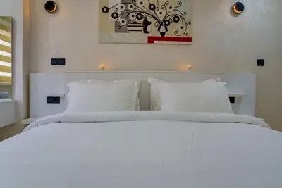 a white bed with white pillows in a bedroom at Elegance in Oulad Akkou