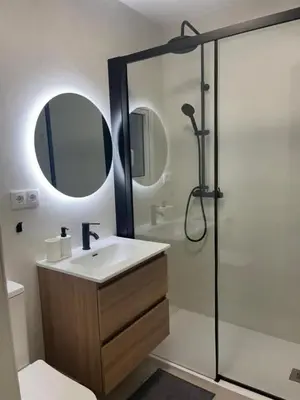 a bathroom with a sink and a shower with a mirror at Yacout 1 in Fès