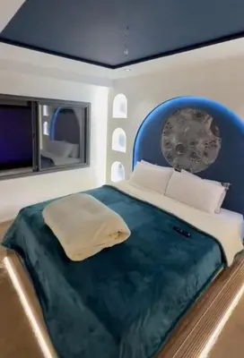a bedroom with a large bed with a blue headboard at Yacout 1 in Fès