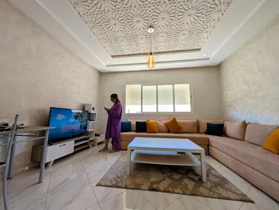 a woman is standing in a living room at Yacout 1 in Fès
