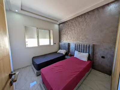a bedroom with two beds and a window at Yacout 1 in Fès