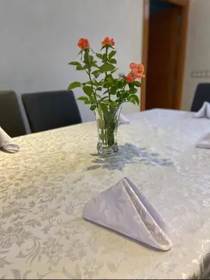 a vase with flowers on a table with a napkin at Villa Tounaroz in Marrakech