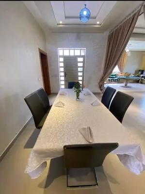 a dining room with a table and chairs at Villa Tounaroz in Marrakech