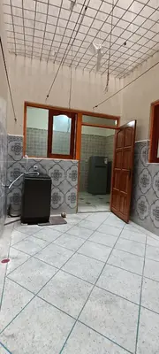 an empty room with a door and a tile floor at belle vue in Meknès