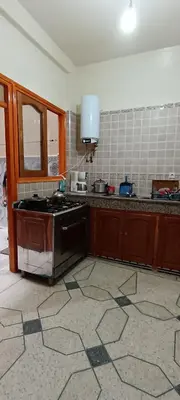 a kitchen with a stove and a sink in it at belle vue in Meknès