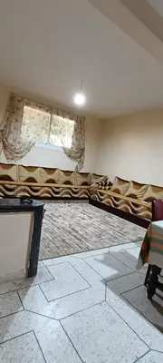 a living room with a long couch in a room at belle vue in Meknès