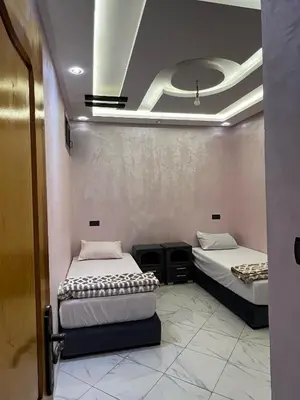 two beds are in a room with at Dakhla in Oulad Akkou