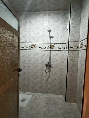 a bathroom with a shower with a glass door at Dakhla in Oulad Akkou