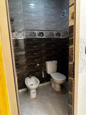 a small bathroom with a toilet and a bidet at Dakhla in Oulad Akkou