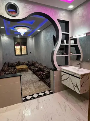 a bathroom with a sink and a mirror at Dakhla in Oulad Akkou