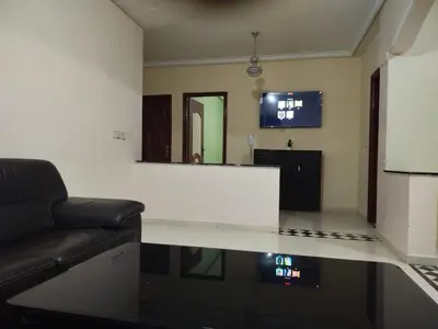 a living room with a couch and a mirror at Riad ezzaytoune 2 in Meknès
