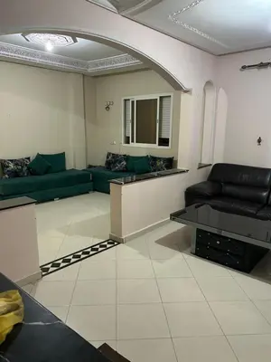 a living room with a couch and a table at Riad ezzaytoune 2 in Meknès