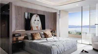 a bedroom with a bed with a large painting on the wall at Villa matudi in Timsernit