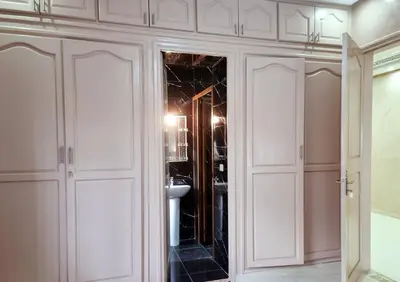 a bathroom with white cabinets and a sink at Hotel&Restaurant Atlas Symphony in Ourika