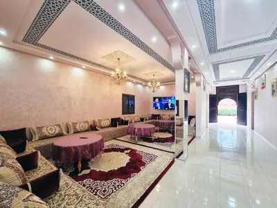 a lobby of a hotel with a couch and tables at Hotel&Restaurant Atlas Symphony in Ourika