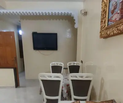 a room with four chairs and a television on a wall at Apparemment Mehdi in Fès
