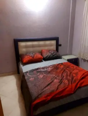 a bedroom with a bed with two pillows on it at Apparemment Mehdi in Fès