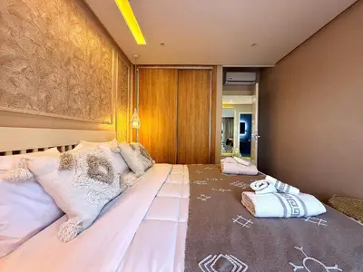 a bedroom with a large bed with pillows on it at New appart moderne à Gueliz , charme et confort in Oulad Akkou