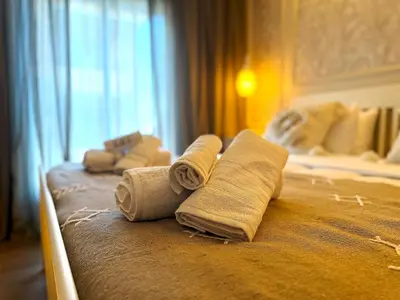 a hotel room with rolled towels on a bed at New appart moderne à Gueliz , charme et confort in Oulad Akkou