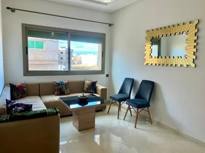 a living room with a couch and chairs and a mirror at Residence Noor - Central Apartments Fes in Fès