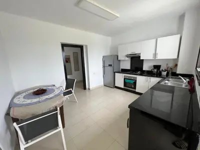 a kitchen with white cabinets and a counter top at كابو نيكرو in Oulad Akkou