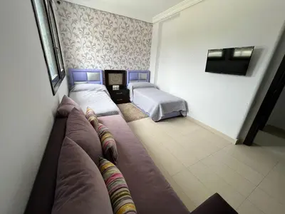 a small room with two beds and a couch at كابو نيكرو in Oulad Akkou