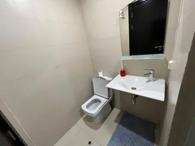a white bathroom with a toilet and a sink at كابو نيكرو in Oulad Akkou