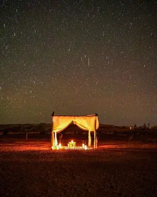 a tent in the middle of the desert under a night sky at Desert Campo in Oulad Akkou