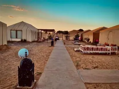 a walkway leading to a group of tents at Desert Campo in Oulad Akkou