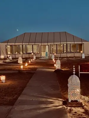 a building with a lot of lights in front of it at Desert Campo in Oulad Akkou