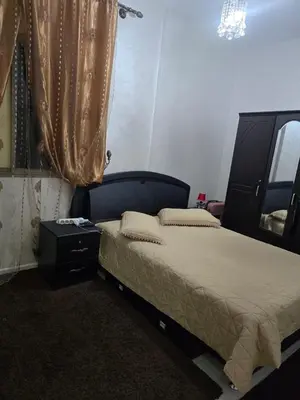a bedroom with a large bed and a window at Apparemment pour vacances in Oulad Akkou
