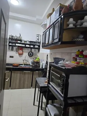 a kitchen with a stove top oven in a room at Apparemment pour vacances in Oulad Akkou
