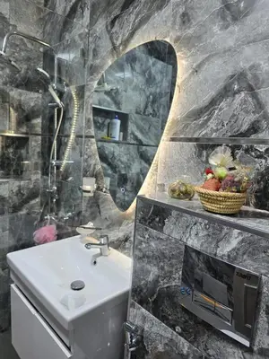 a bathroom with a sink and a mirror at Apparemment pour vacances in Oulad Akkou