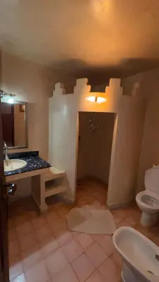 a bathroom with a sink and a toilet at Hotel Kasbah Fenguig in Er Rachidia