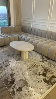 a living room with a table and a couch at appartement Golf Prestigia 3 chambres in Oulad Akkou