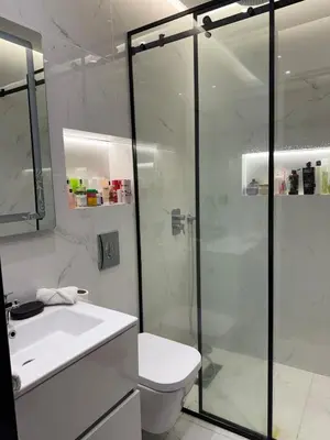 a bathroom with a shower and a toilet and a sink at appartement Golf Prestigia 3 chambres in Oulad Akkou