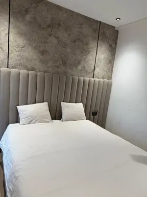 a bedroom with a white bed with two pillows at appartement Golf Prestigia 3 chambres in Oulad Akkou