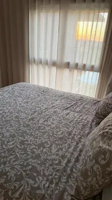 a bed in a bedroom with a window at appartement Golf Prestigia 3 chambres in Oulad Akkou