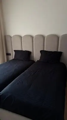 two beds sitting next to each other in a bedroom at appartement Golf Prestigia 3 chambres in Oulad Akkou