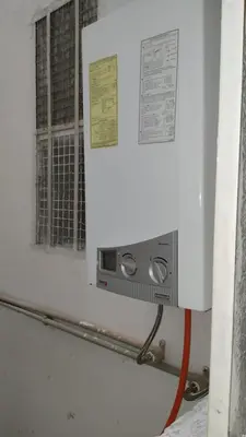 a microwave on a wall next to a window at appartement Tanger in Oulad Akkou