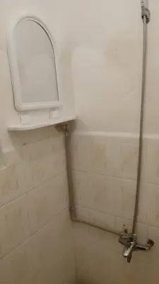 a bathroom with a shower and a mirror on the wall at appartement Tanger in Oulad Akkou