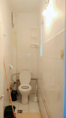 a white bathroom with a toilet in a room at appartement Tanger in Oulad Akkou