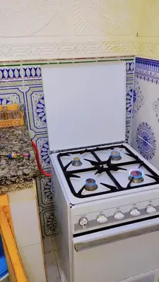 a white stove top oven sitting in a kitchen at appartement Tanger in Oulad Akkou
