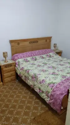 a bedroom with a bed and a dresser with a bed sidx sidx at appartement Tanger in Oulad Akkou