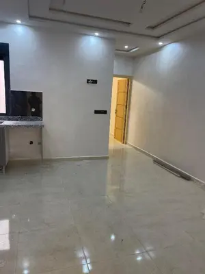 a large empty room with a hallway with a door at Saidia in Oulad Akkou