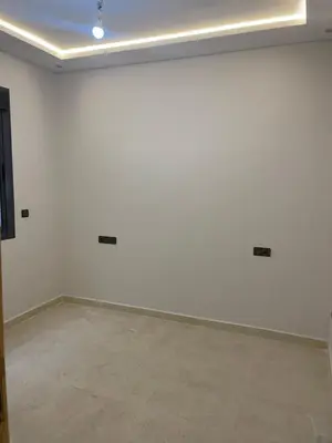 an empty room with white walls and a tile floor at Saidia in Oulad Akkou